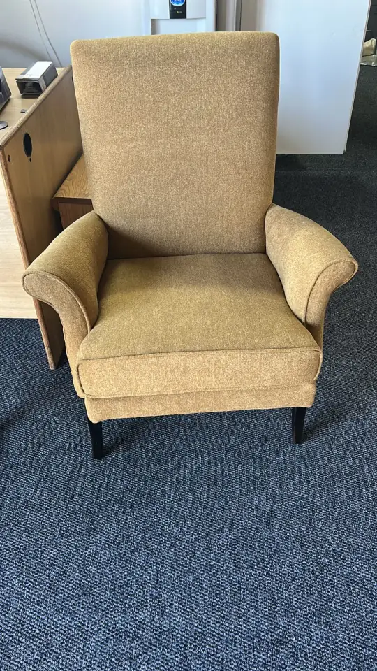 A high-back armchair in mustard