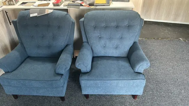 A pair of button-back armchairs in denim blue