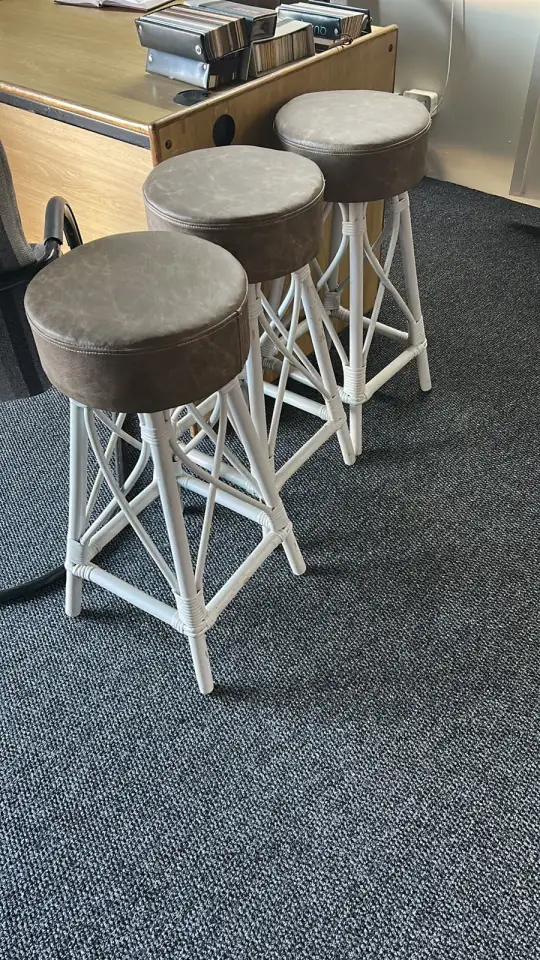 Three bar stools with round upholstered seats
