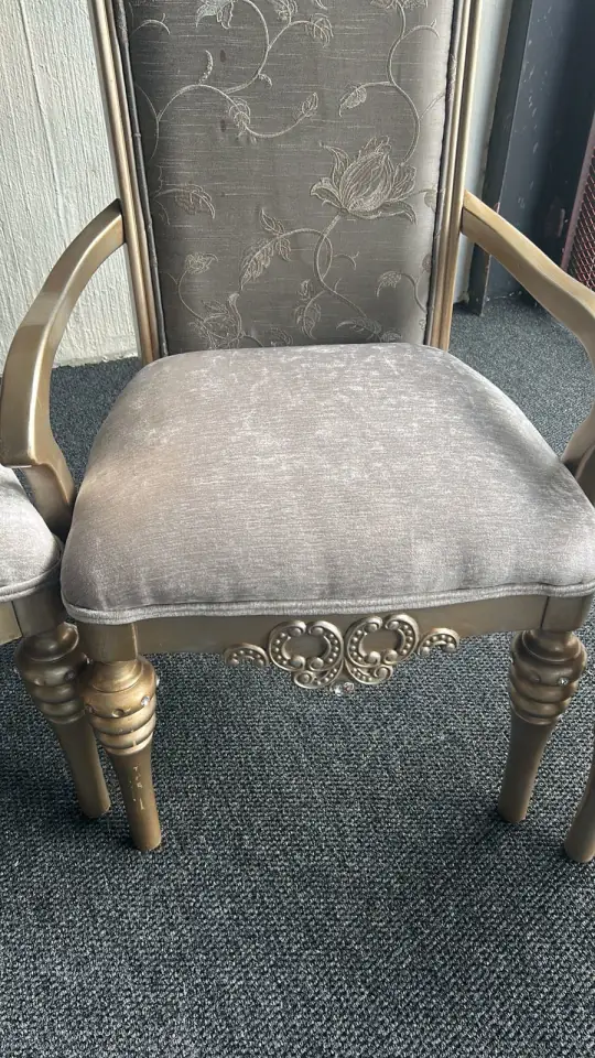 A carver chair in silver damask on a gilded frame