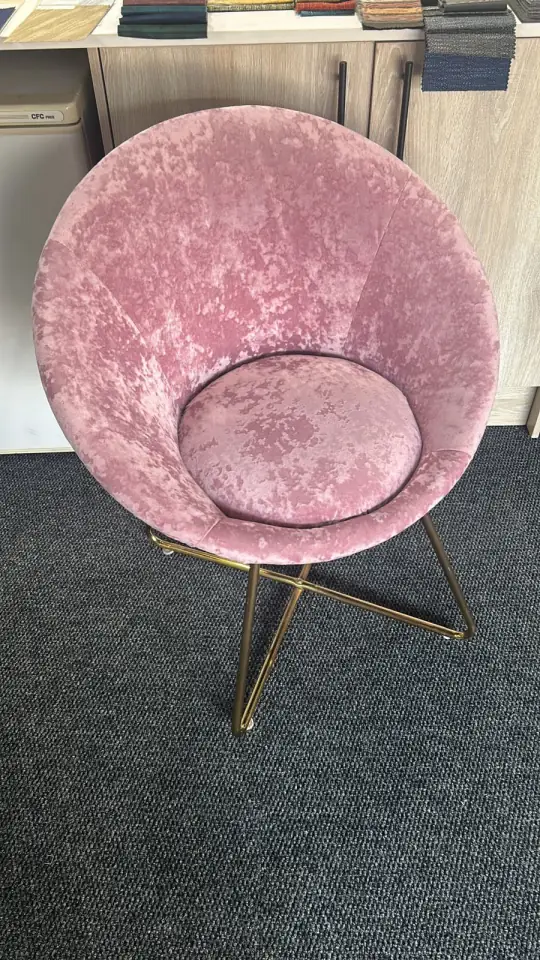 A dish chair in pink crushed velvet on brass legs