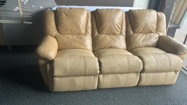 A three-seater recliner in cream leather