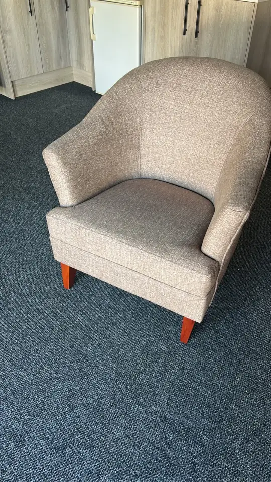 A tub chair in an oatmeal weave