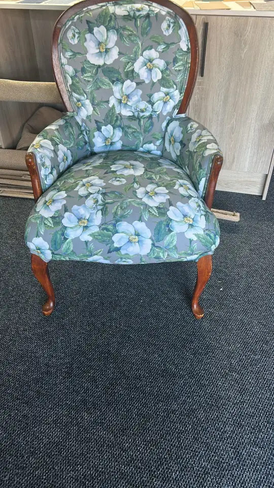 A Victorian armchair in a blue and green floral