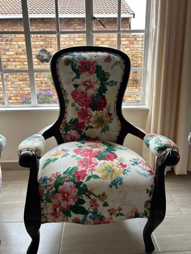 A Victorian armchair in a rose floral fabric