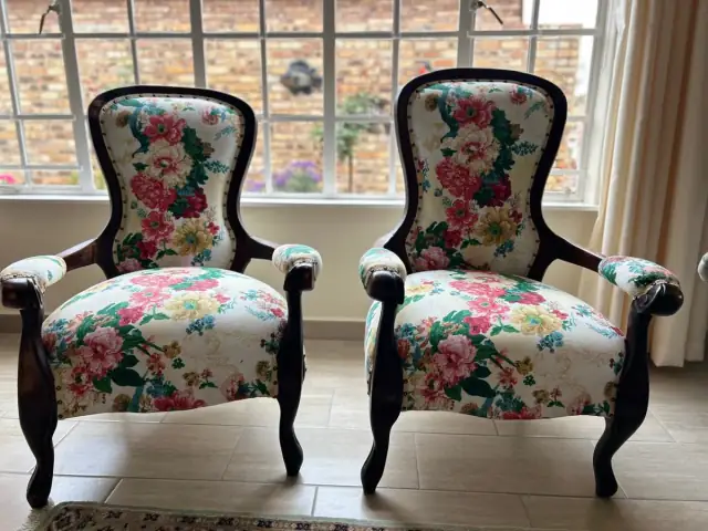 A pair of Victorian armchairs in a rose floral fabric